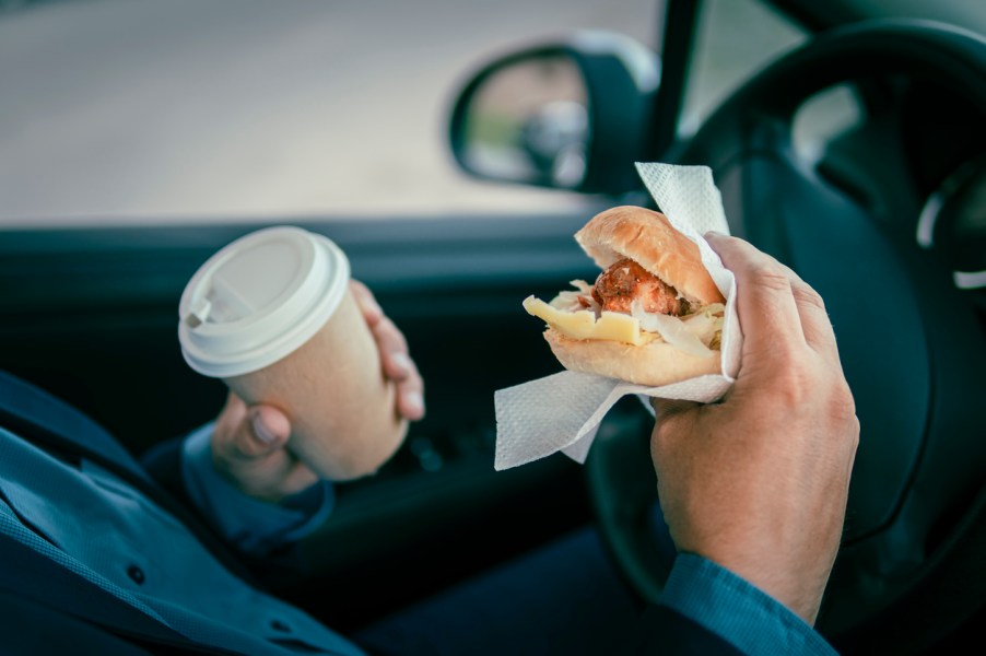 A man driving while eating