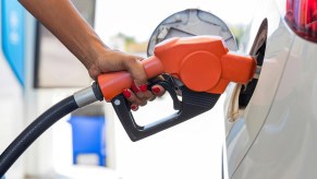 A woman putting gas in her car