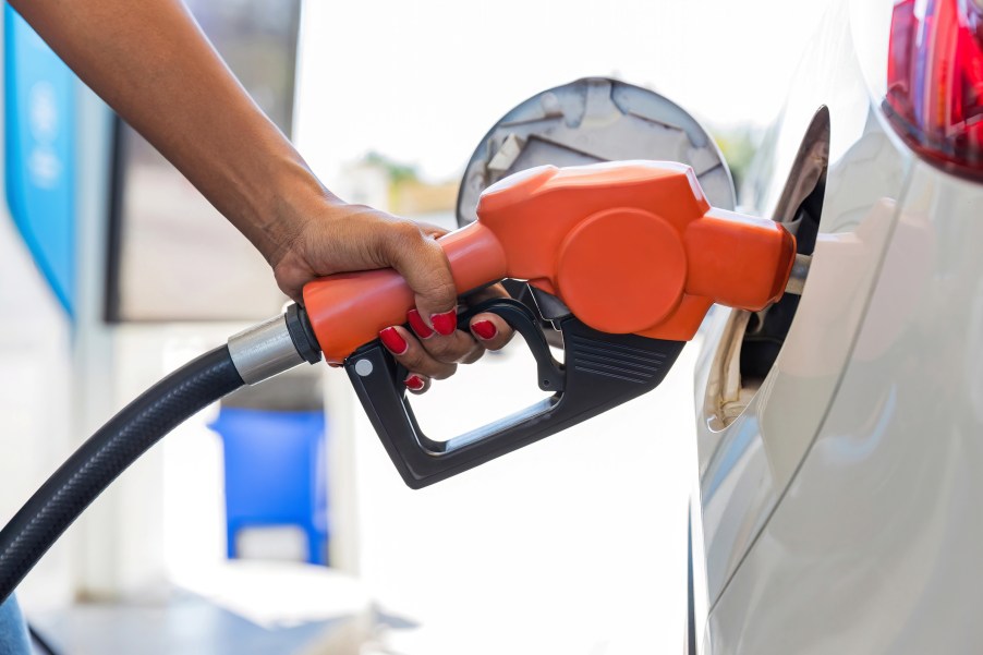 A woman putting gas in her car