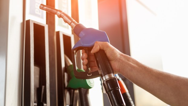 Person holding a gas pump
