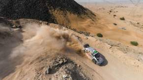 Overhead view of Toyota's Yaris rally car skidding through a mountain switchback during a race in Saudi Arabia.