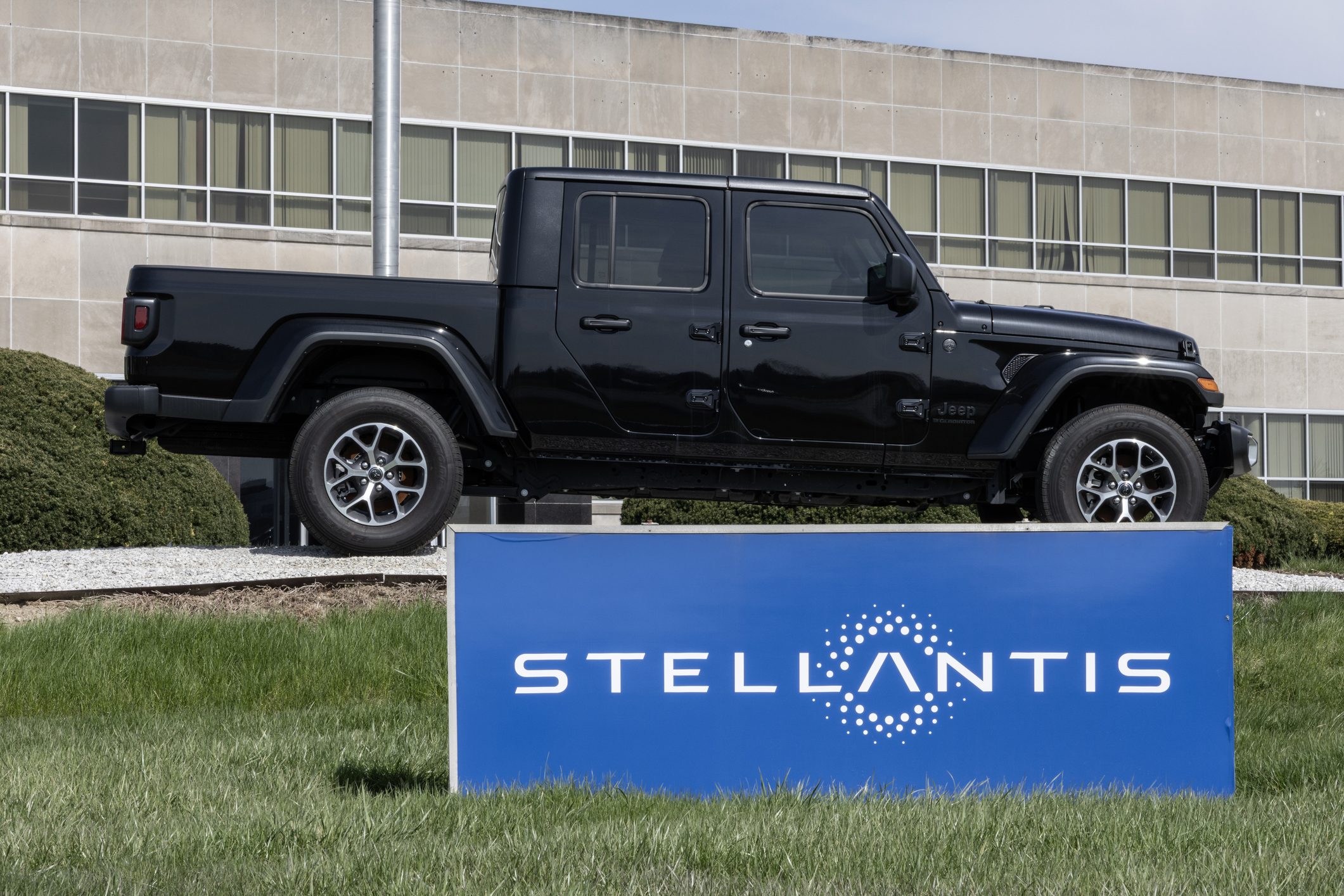 A Jeep Gladiator near a Stellantis sign