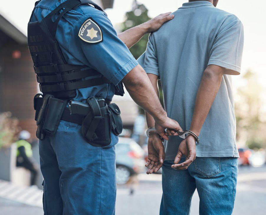 A police officer arresting a man
