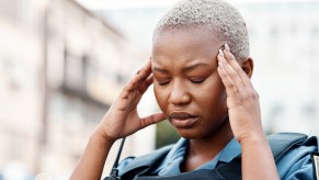 A police officer touching her forehead