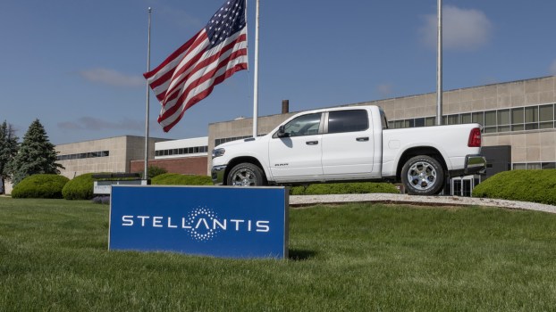 A Ram 1500 truck behind a Stellantis sign