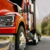Closeup of the bumper and front tires of an 18-wheeler semi truck.