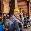 Older factory worker sitting on a pallet in Ontario Brampton.