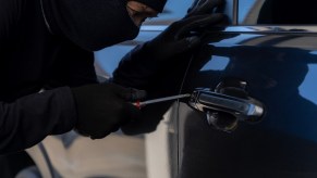 Thief uses a screwdriver to break the lock of 1999 Honda Accord car