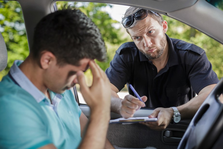 A police officer writing a traffic ticket