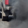 A truck rolling coal on the road