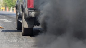 A truck rolling coal on the road