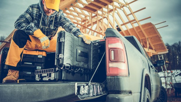 A man in the bed of a work truck