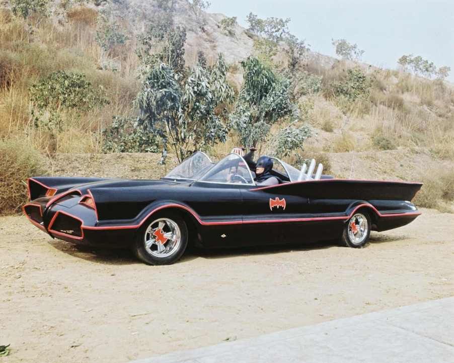 Adam West as Batman driving the Batmobile in 1966