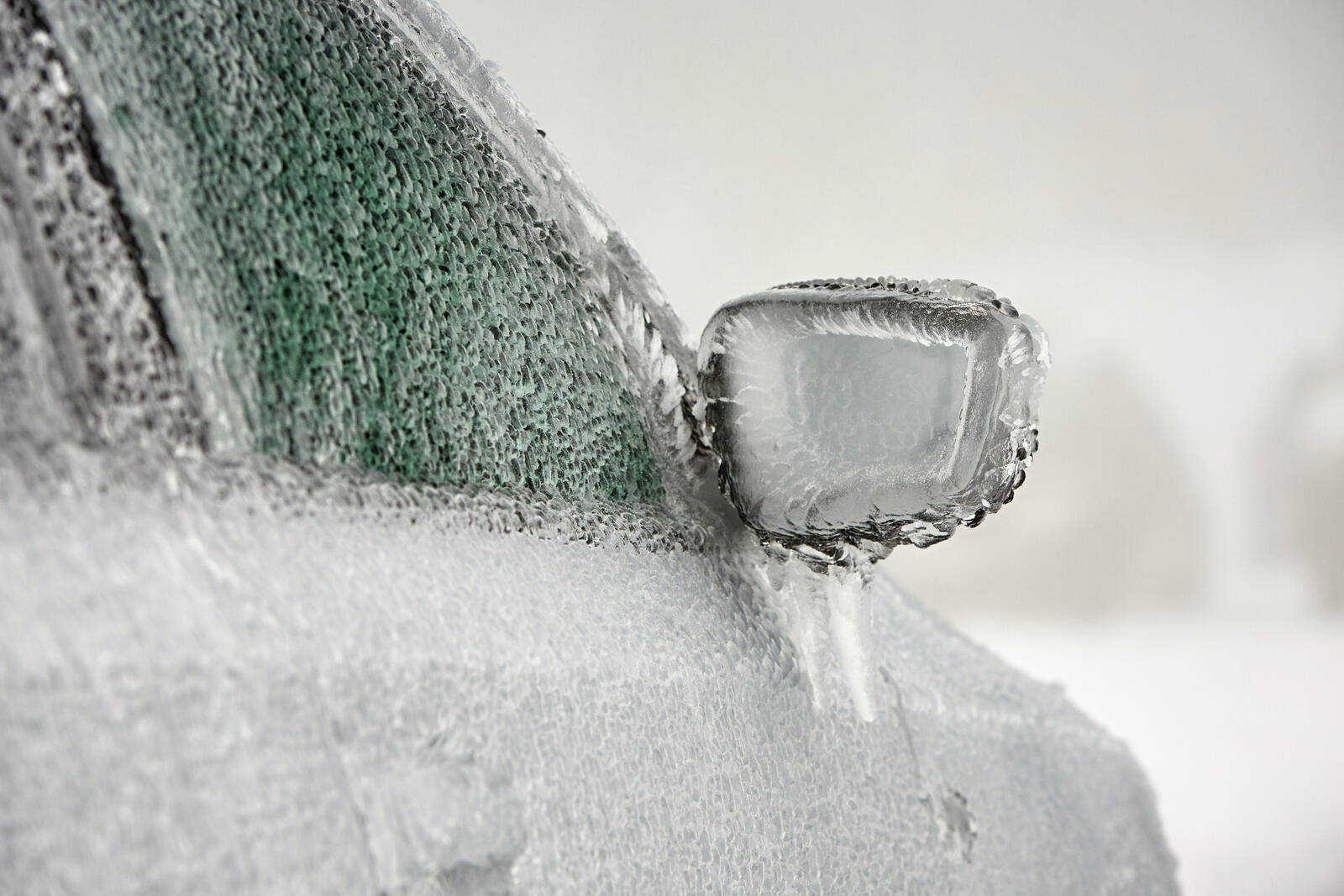 A car covered in ice in close view of right front