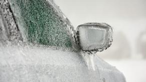 A car covered in ice in close view of right front