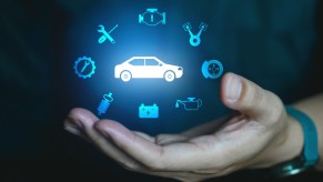 Illuminates vehicle maintenance light data icons floating in air above open hand