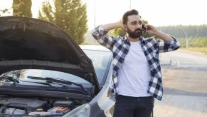 Driver on cell phone after experiencing a car breakdown