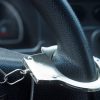 A handcuff on a car steering wheel in close view