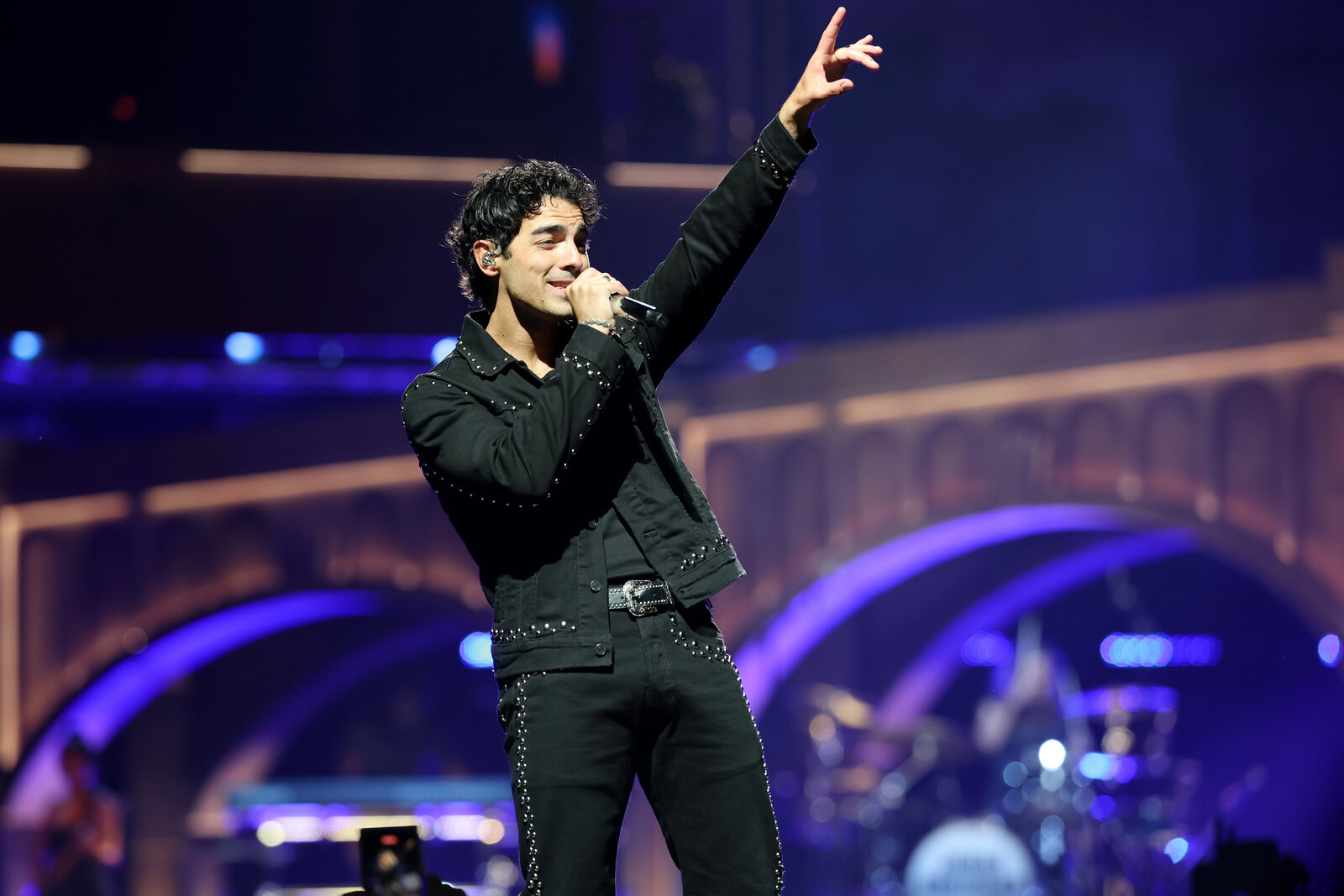 Joe Jonas performing on stage in 2025