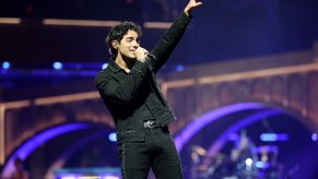 Joe Jonas performing on stage in 2025