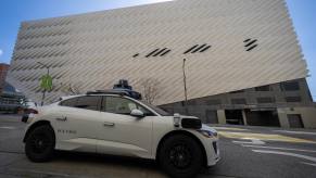 Closeup of a Waymo taxi driving on a San Francisco street.