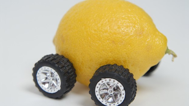 A lemon on wheels, depiction of a used car that's a money pit