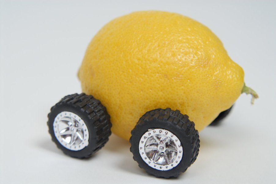 A lemon on wheels, depiction of a used car that's a money pit