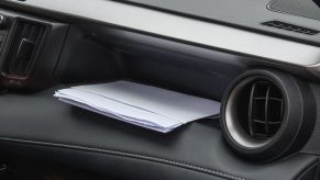 Mail sitting in a car's front dash compartment