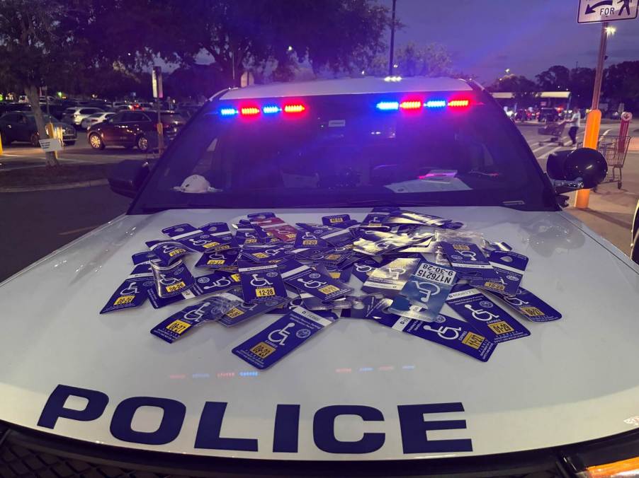 Mount Dora, Florida police collect misused handicap placards on cruiser hood at night