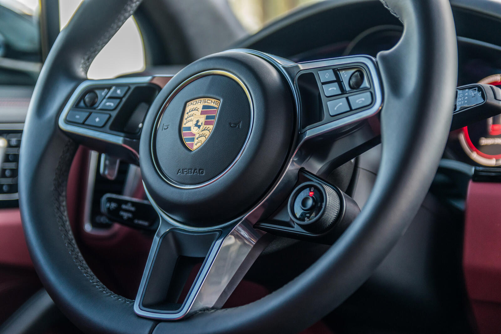 The steering wheel of a Porsche Cayenne in close view