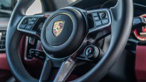 The steering wheel of a Porsche Cayenne in close view