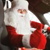 Santa driving a car giving viewer thumbs up
