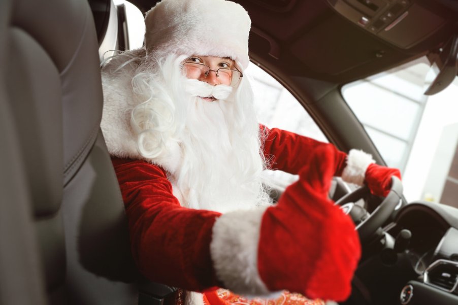 Santa driving a car giving viewer thumbs up