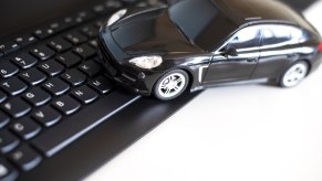 A black tow car on a computer keyboard