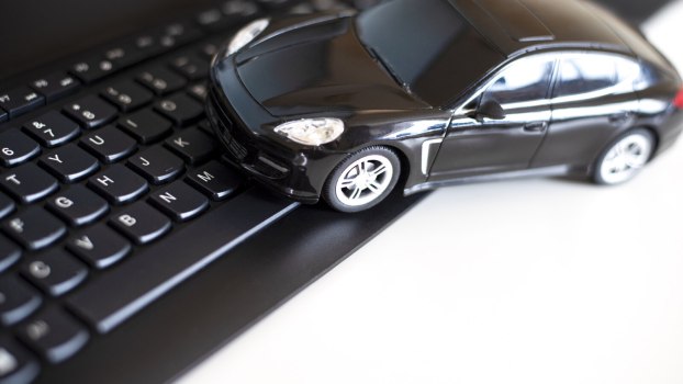 A black tow car on a computer keyboard
