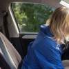 A blonde woman driver slumped over her steering wheel DUI depiction
