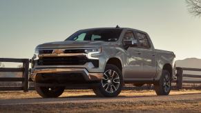 The 2025 Chevy Silverado 1500 near a fence