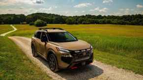 The 2025 Nissan Rogue on a dirt road
