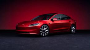 The 2025 Tesla Model 3 against a red background