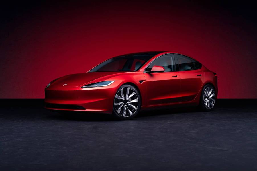 The 2025 Tesla Model 3 against a red background