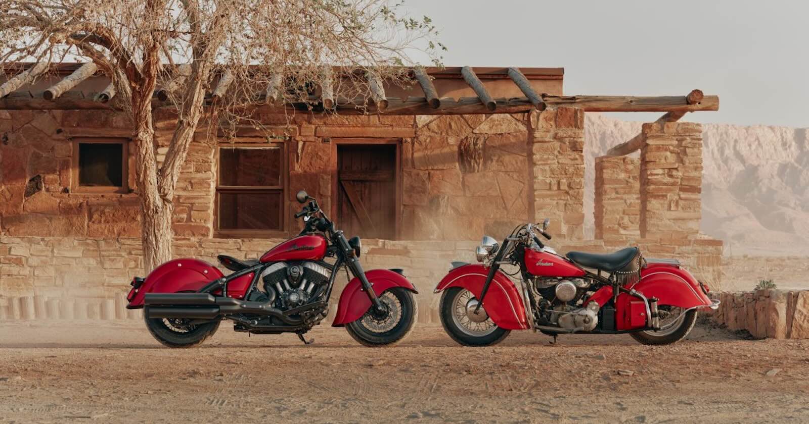 Indian's new vintage-style Chief and the original 1940s motorcycle parked side-by-side, a stucco desert house in the background.
