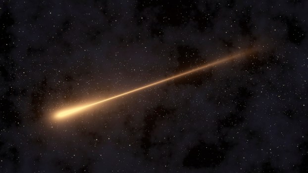 Orange comet streaking through space in front of stars.