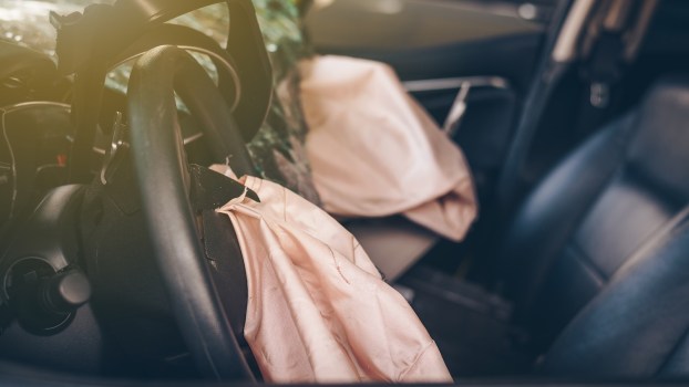 Airbags inflated in a sedan after a crash.