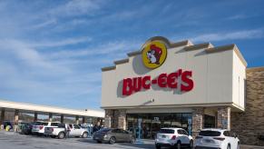 The red Buc-ee's sign on the front of a convenience store, gas station in the background.
