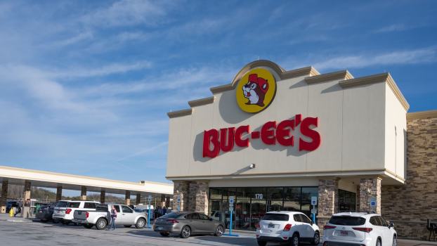 The red Buc-ee's sign on the front of a convenience store, gas station in the background.