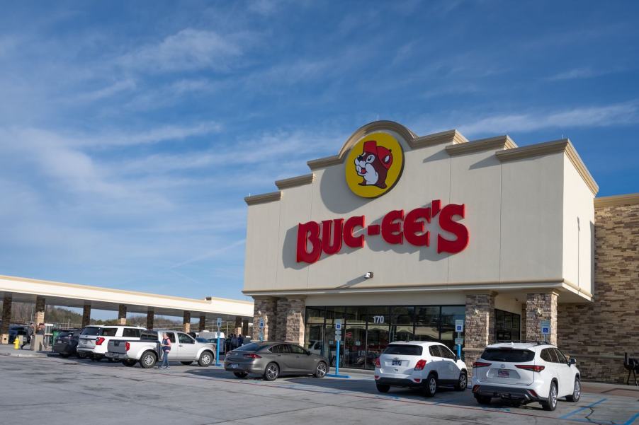 The red Buc-ee's sign on the front of a convenience store, gas station in the background.