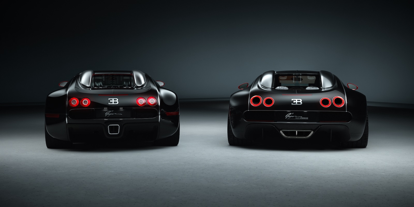 The rear of a black Bugatti Veyron and FKP Hommage special edition Chiron.