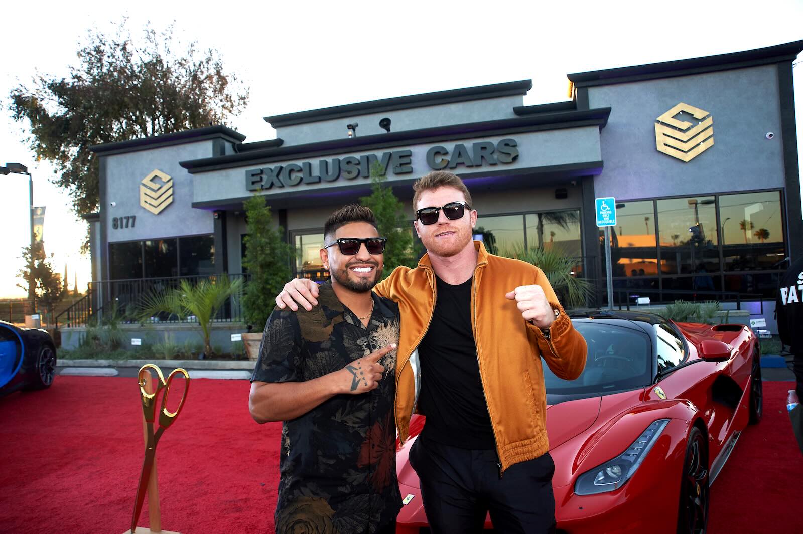 Boxer Canelo Alvarez poses on the red carpet during the grand opening of his exotic car dealership