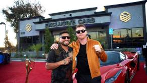 Boxer Canelo Alvarez poses on the red carpet during the grand opening of his exotic car dealership
