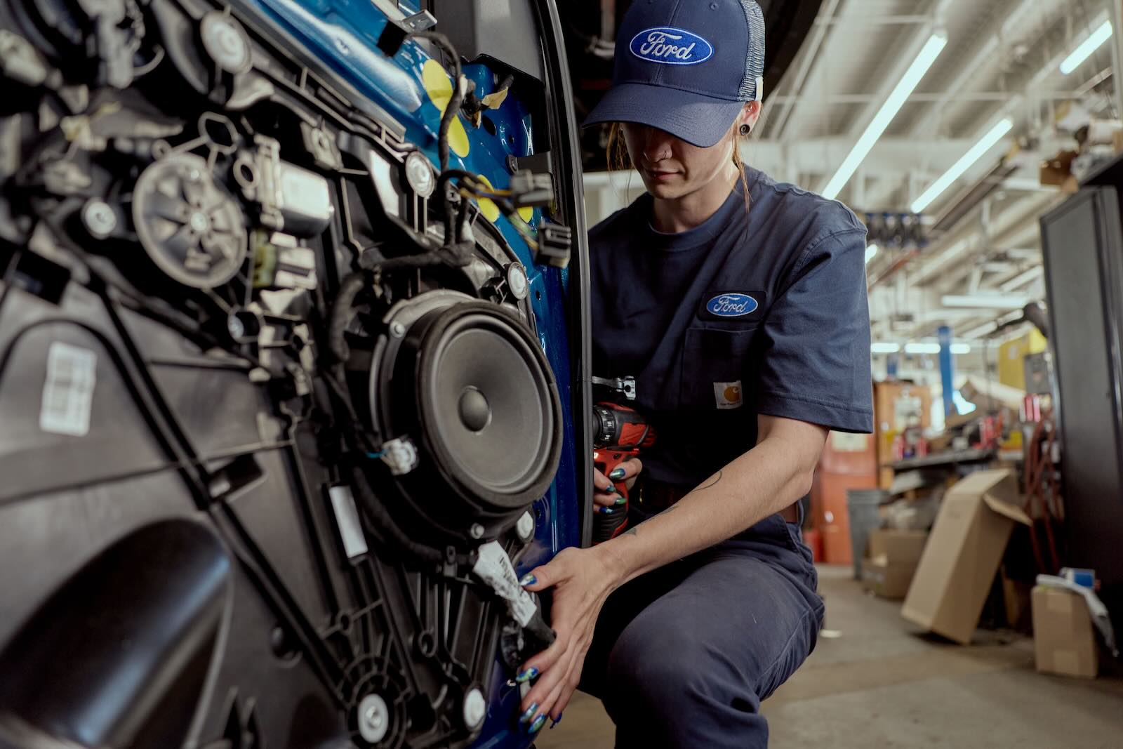 Ford dealership technician in a Carhartt hat and t-shirt